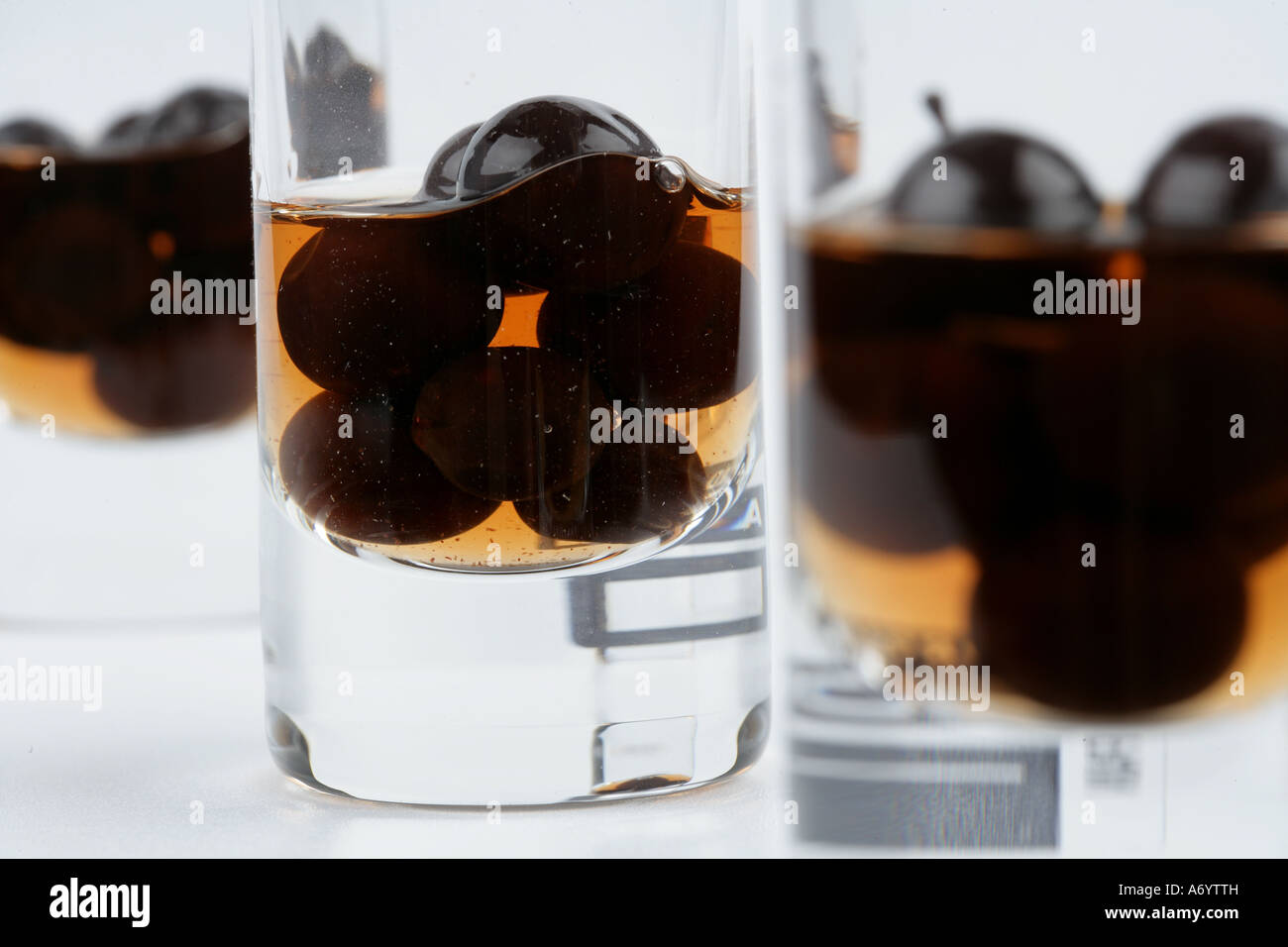 Sloe gin shots with sloe berries inside Stock Photo Alamy