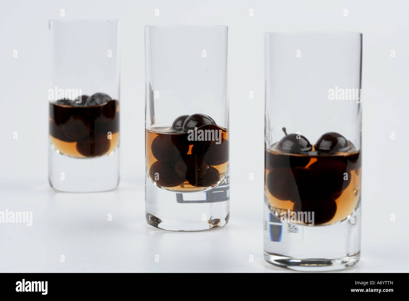 Sloe gin shots with sloe berries inside Stock Photo