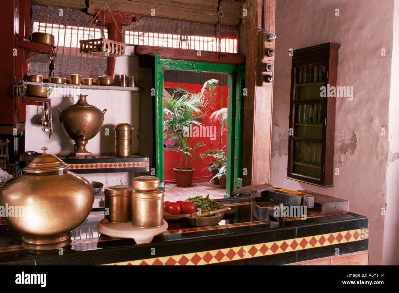 Kitchen area with traditional brass cooking utensils and samovar in