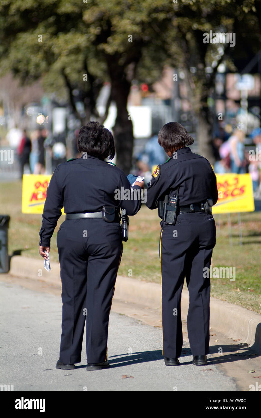 two police women walking in the street in Dallas Stock Photo - Alamy