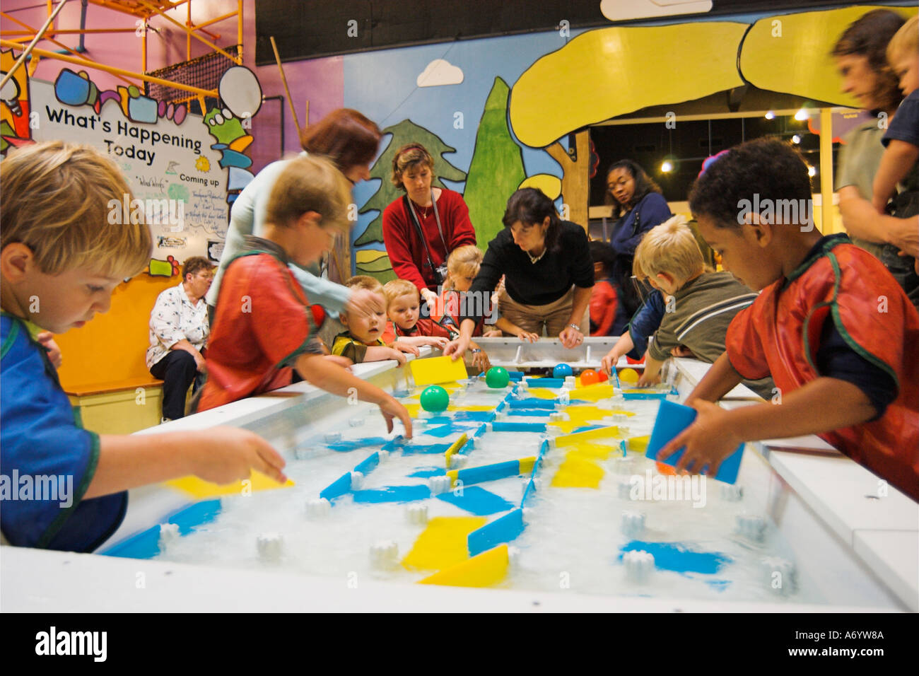Children and mothers at water play activity at the Children s Museum ...