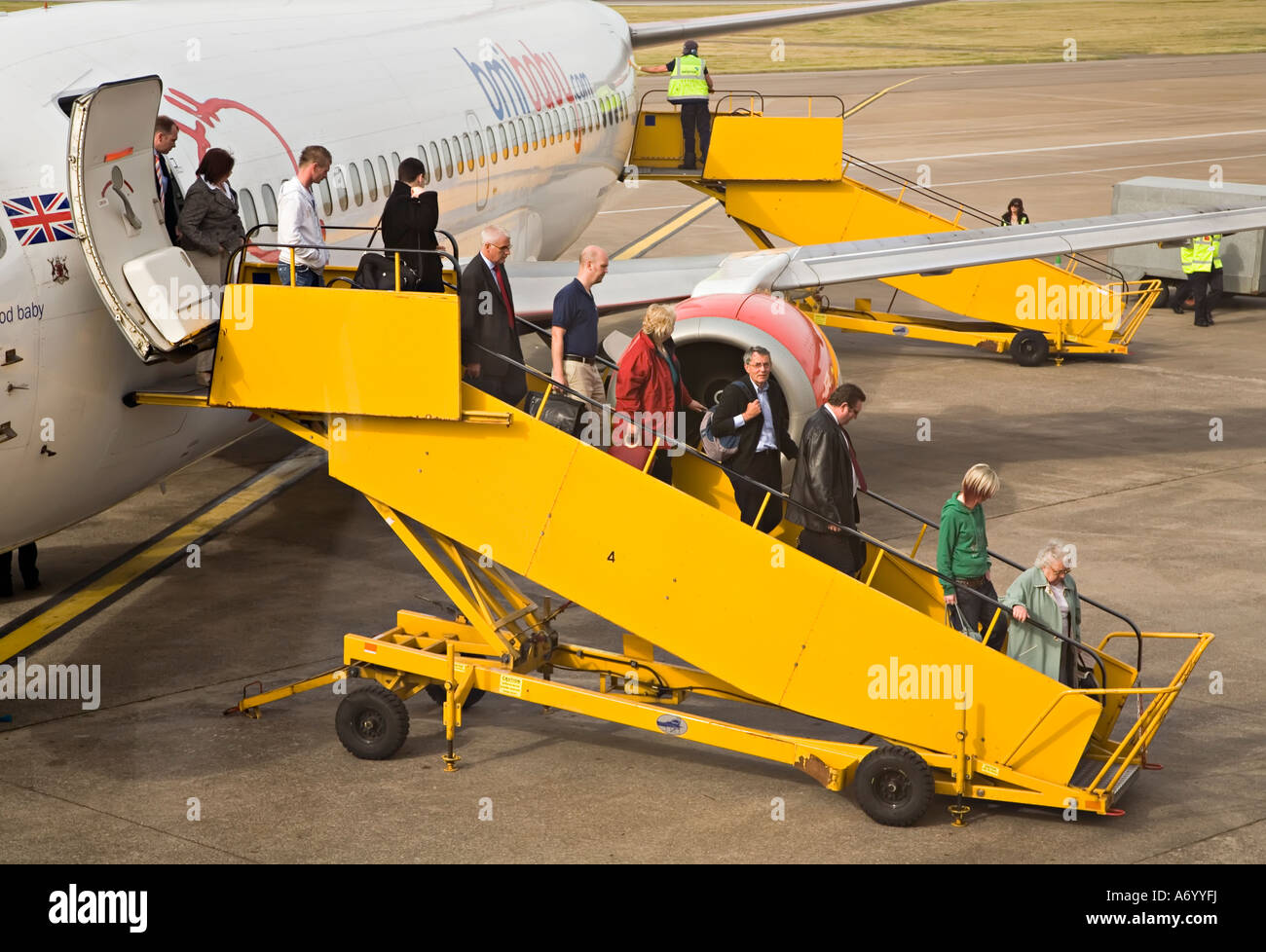 Passengers disembarking from BMI Baby aircraft Cardiff airport Wales UK Stock Photo