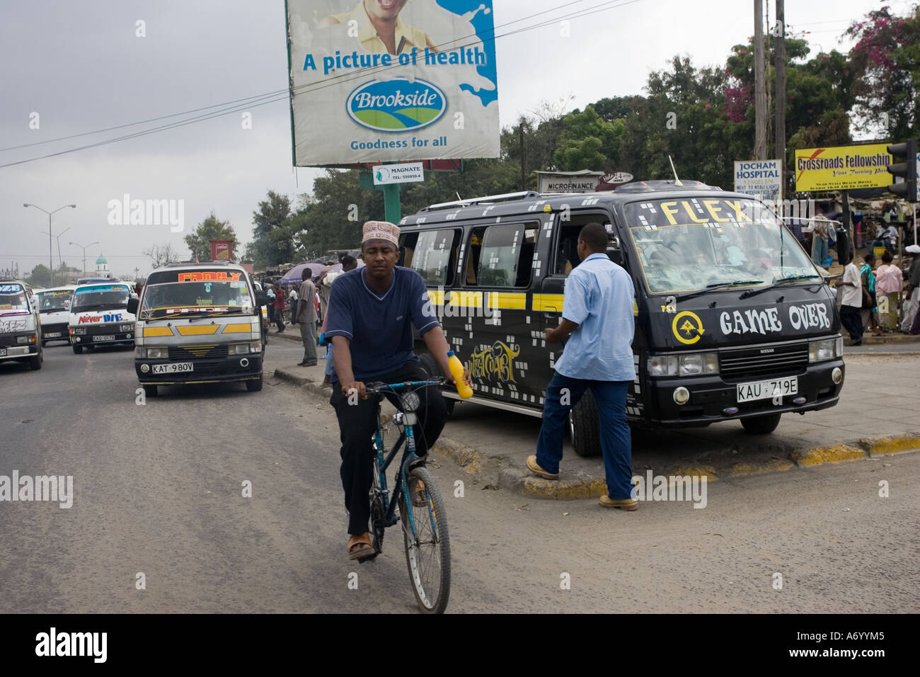 African taxis and bicycle in African street scene Mombasa Kenya East Africa Stock Photo