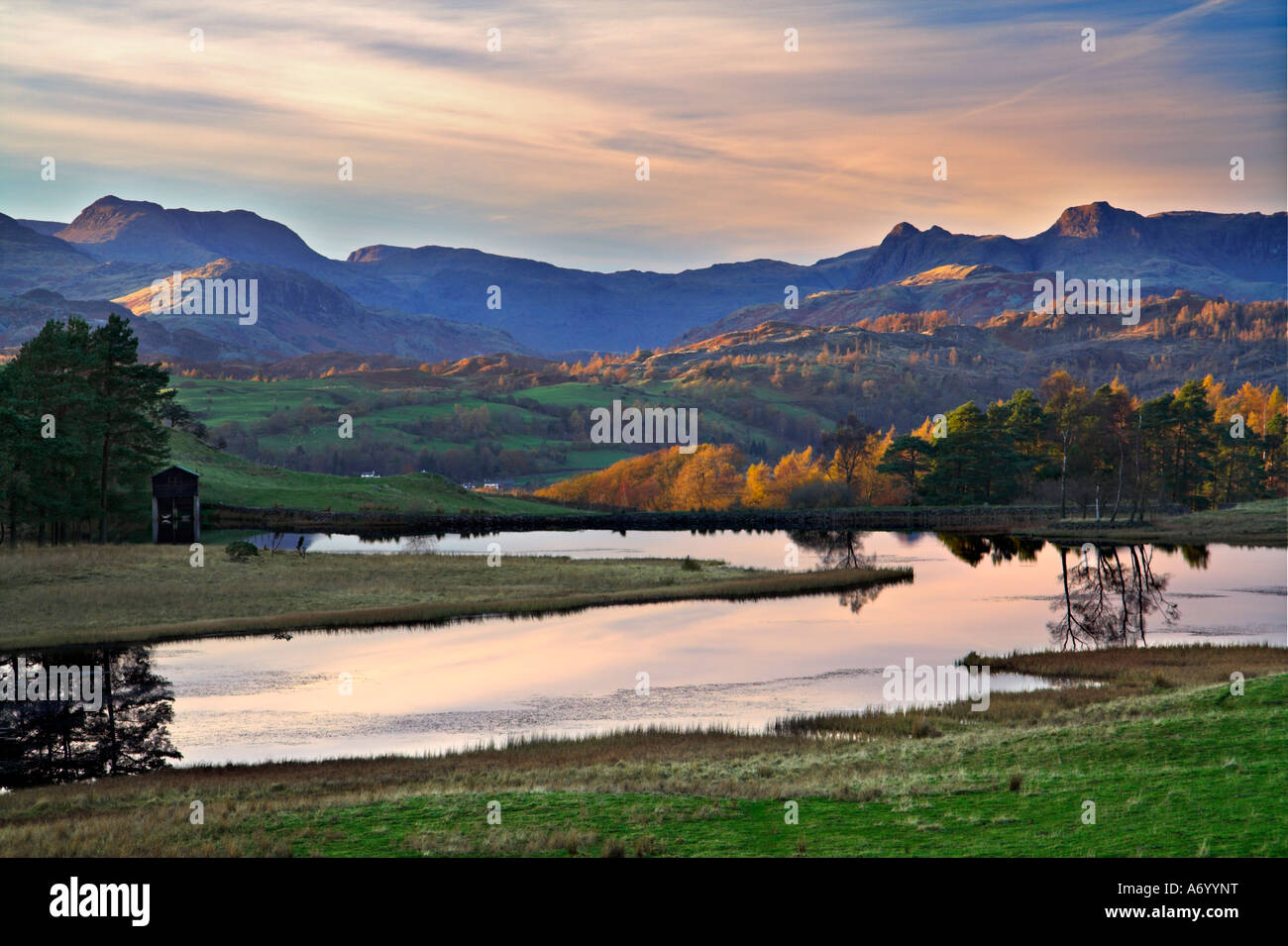 Wise Een tarn and the Langdale Pikes Cumbria England Stock Photo