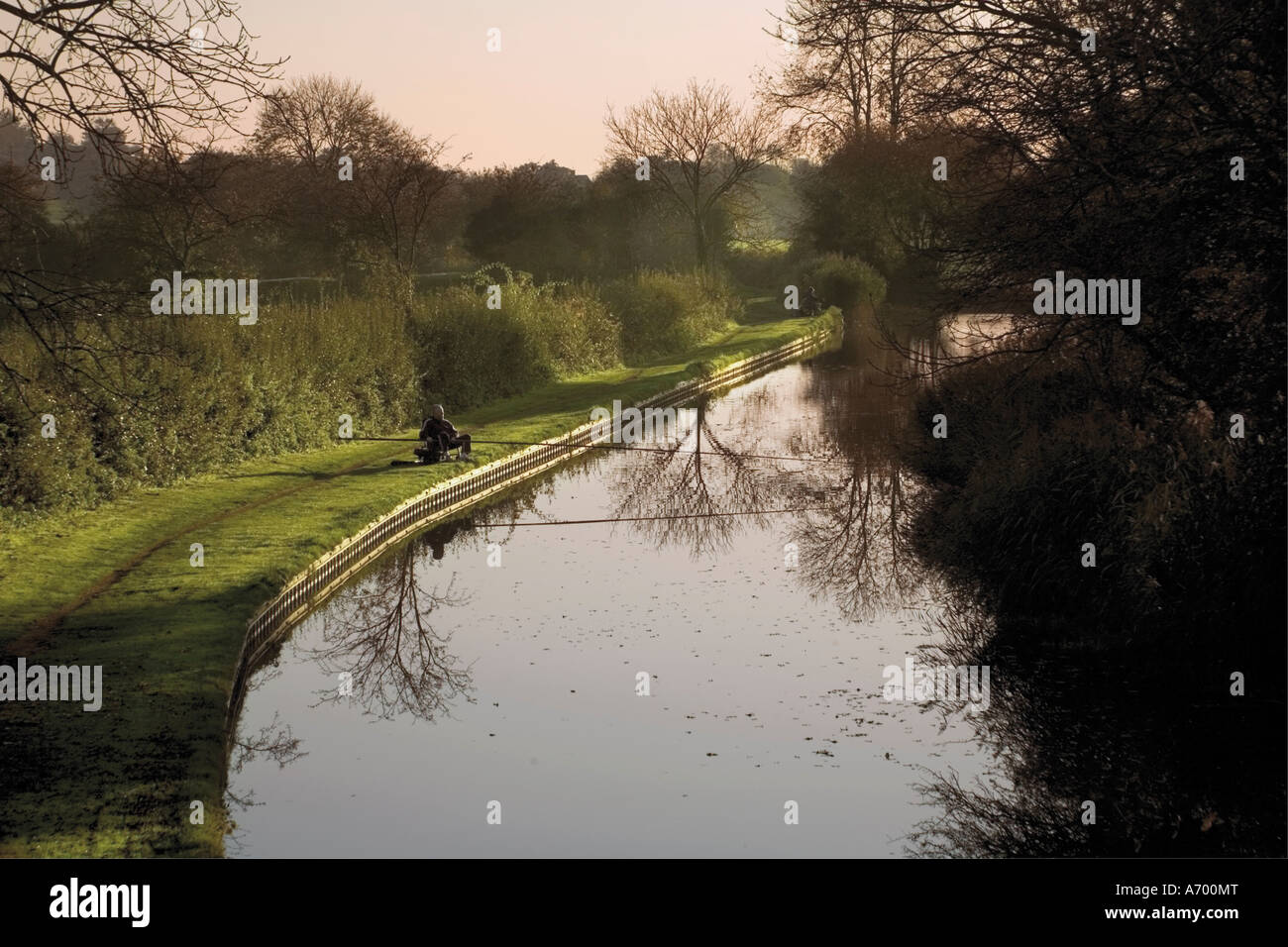 Man fishing from the towpath Worcester and Birmingham canal Hanbury Worcestershire Midlands England United Kingdom Europe Stock Photo