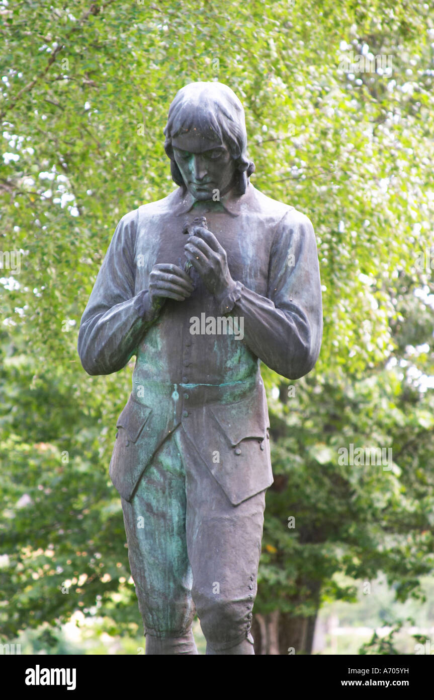 A statue of Carl Linnaeus holding a bird by Gerda Sprinchorn standing in the church yard of Stenbrohult with Linneaus' father w Stock Photo