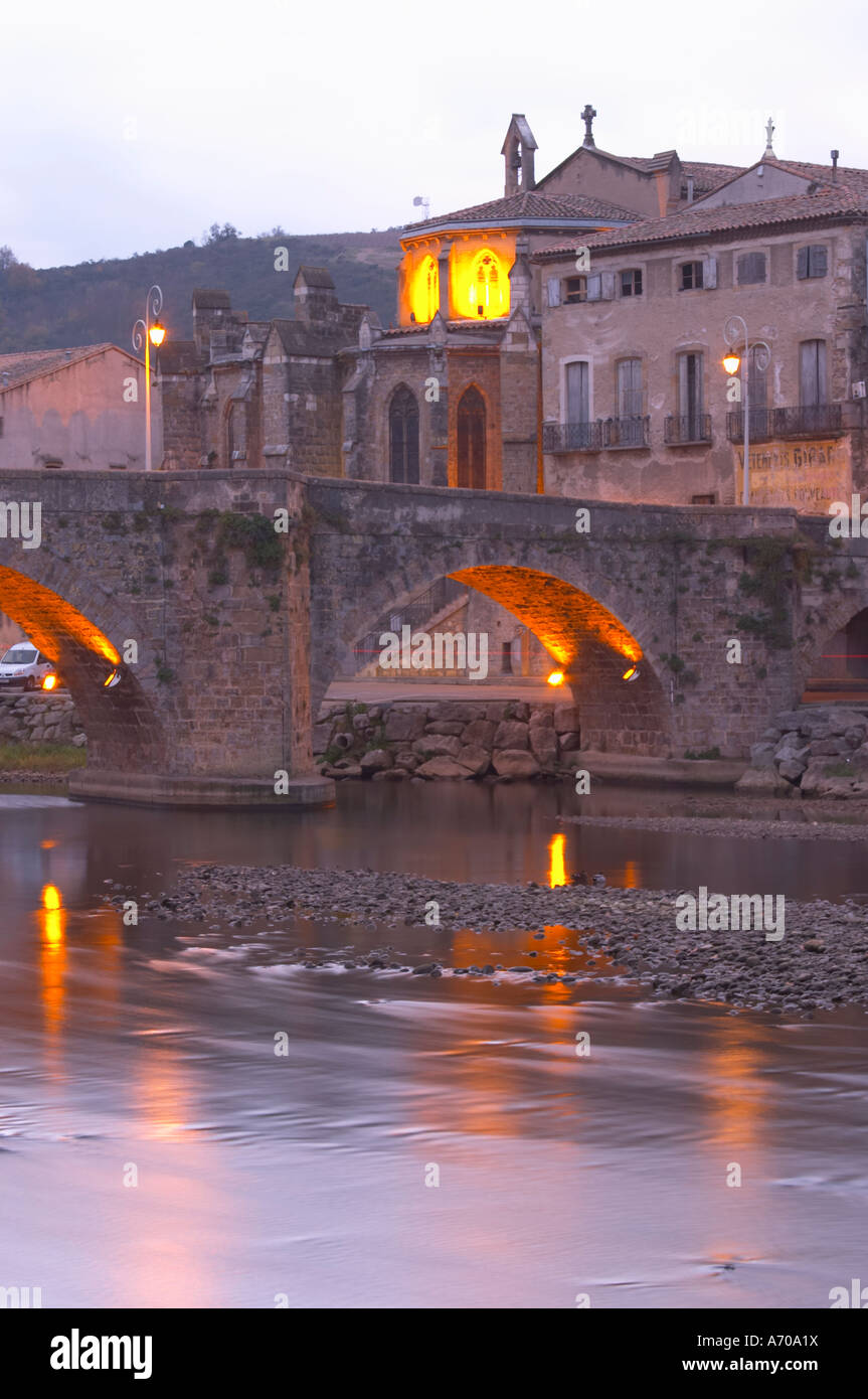 The gothic St Martin Church and the bridge across the l'Aude river. Town of Limoux. Limoux. Languedoc. Aude river. Illuminated at evening time and night. France. Europe. Stock Photo