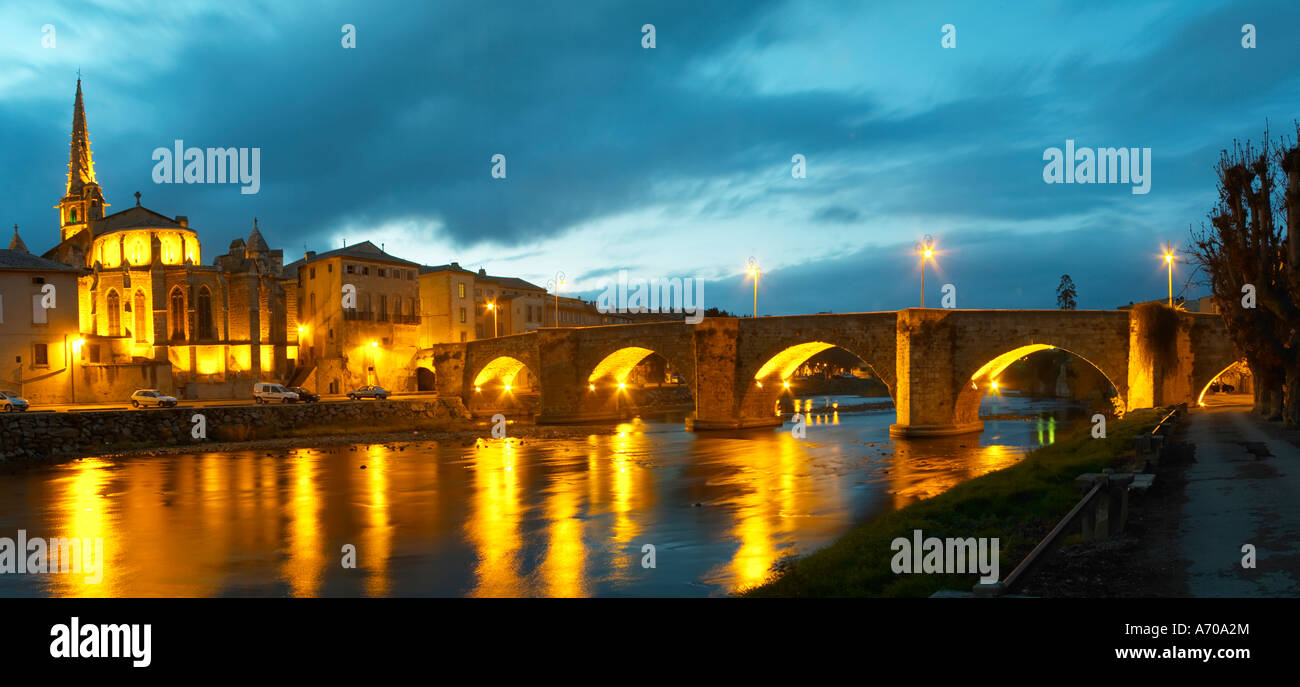 The gothic St Martin Church and the bridge across the l'Aude river. Town of Limoux. Limoux. Languedoc. Aude river. Illuminated at evening time and night. France. Europe. Stock Photo