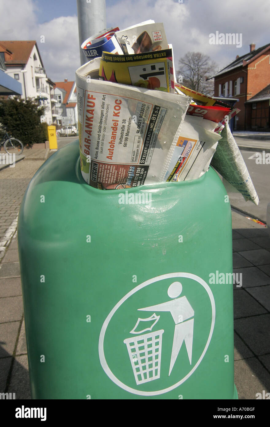Trash can with old newspaper Stock Photo - Alamy