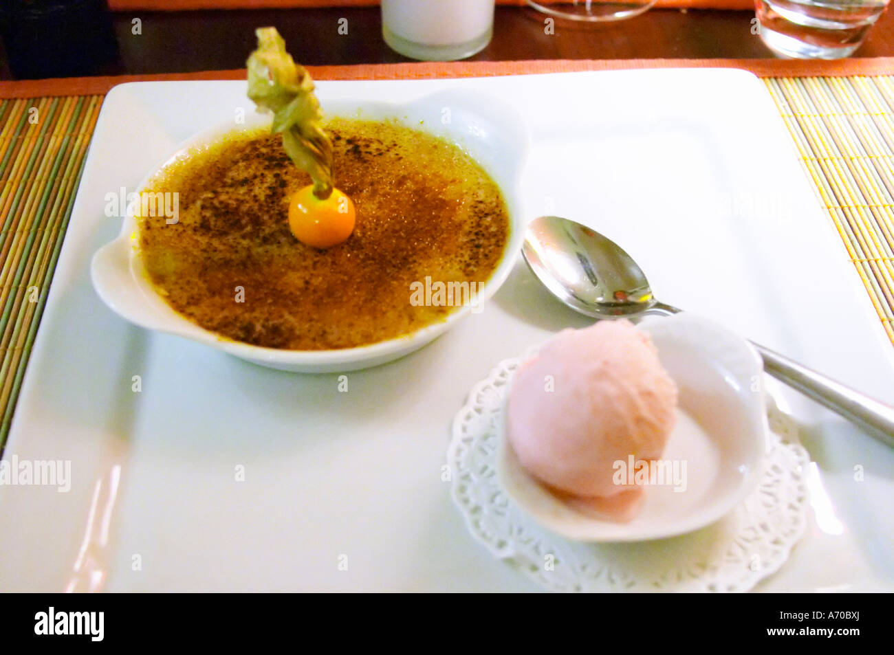Hotel Residence in Nissan-lez-Enserune La Clape. Languedoc. Creme brulee with physalis and chewing gum flavoured ice cream. France. Europe. Stock Photo