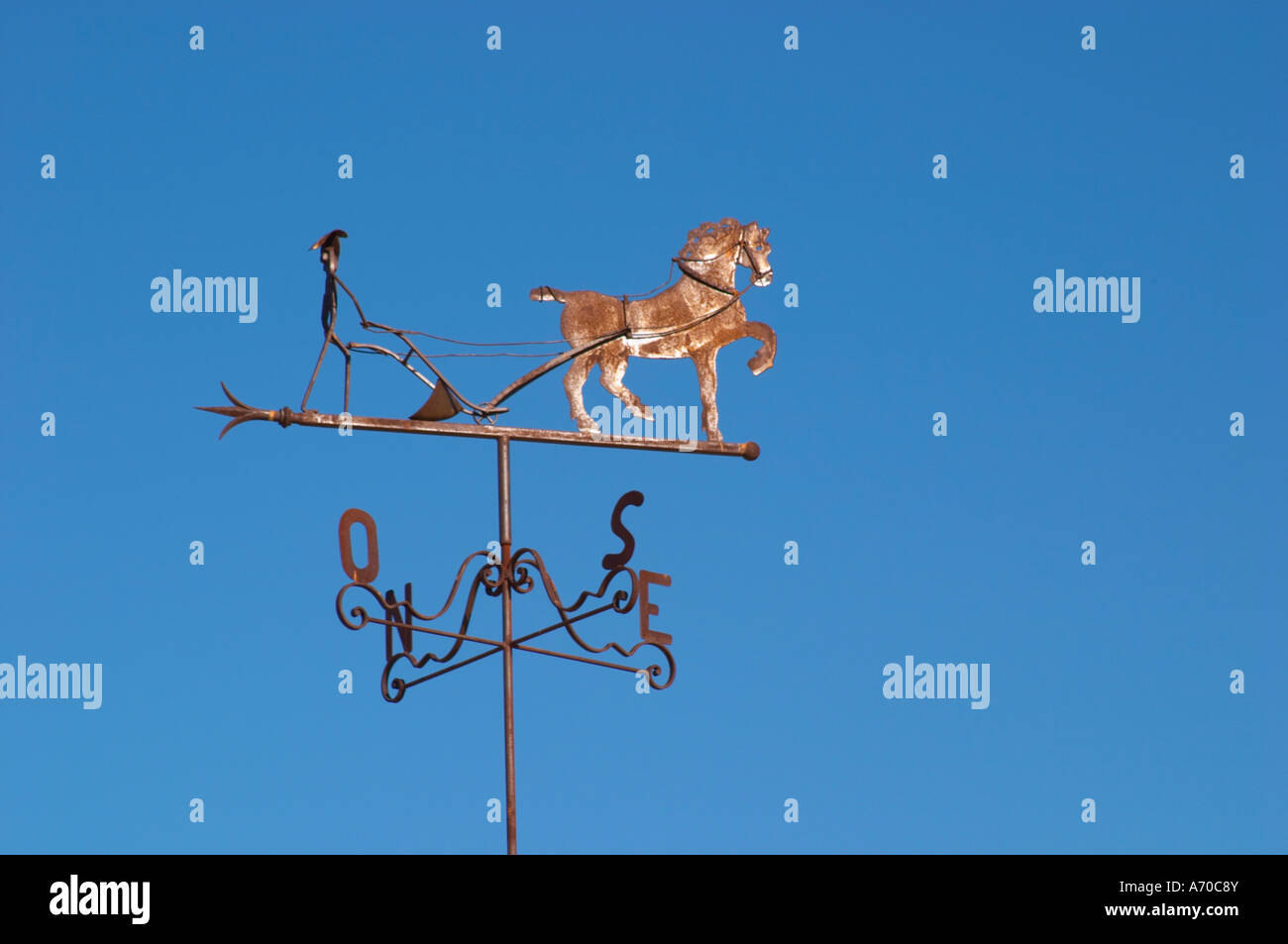 Weather vane with compass directions, depicting a horse and a man that