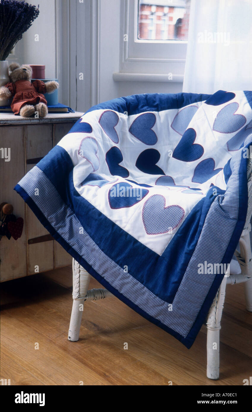 Baby quilt with blue gingham hearts applique Stock Photo - Alamy