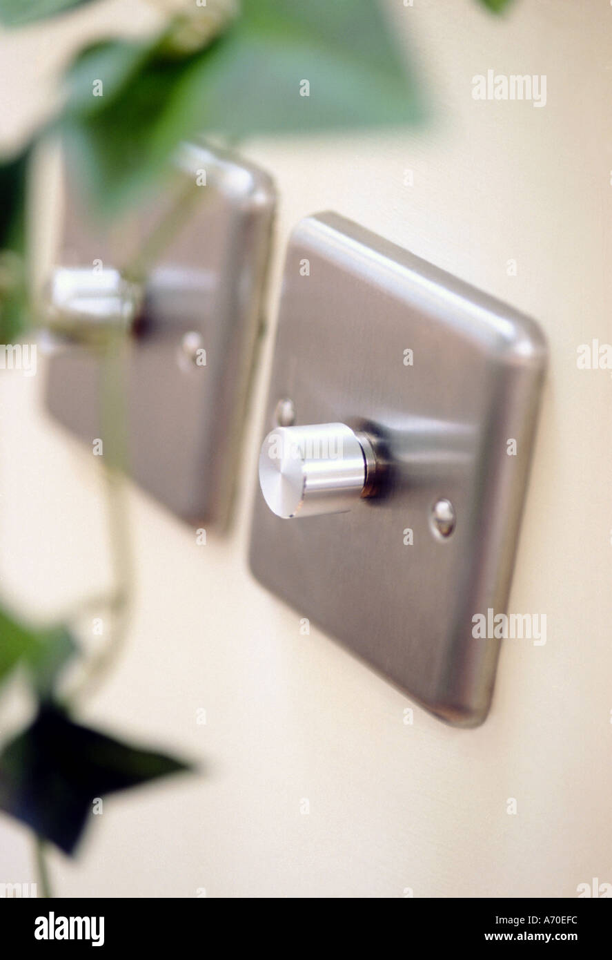 Pair of brushed steel dimmer switches on white wall Stock Photo Alamy