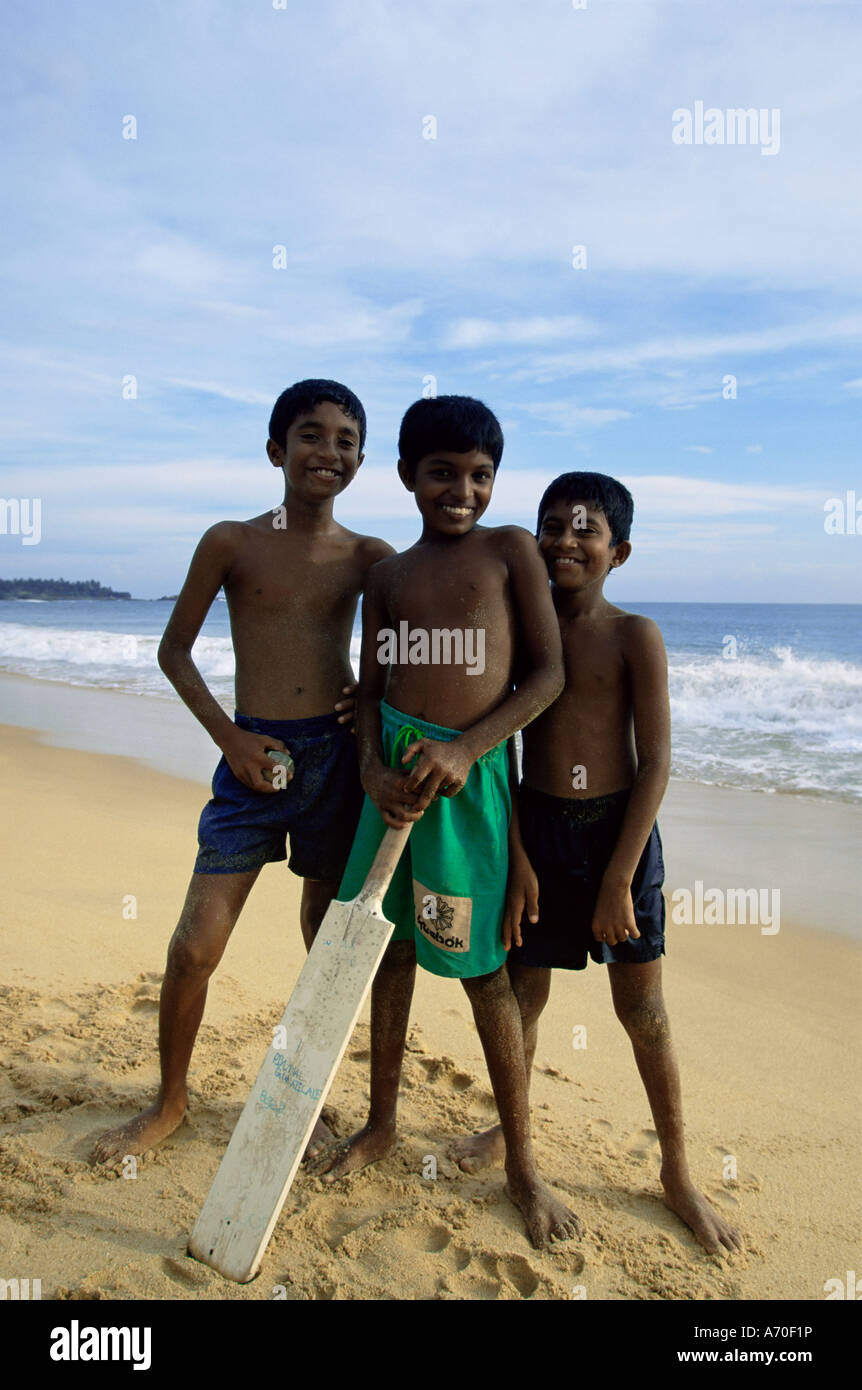 Boys playing cricket Hikkaduwa beach Sri Lanka Asia Stock Photo