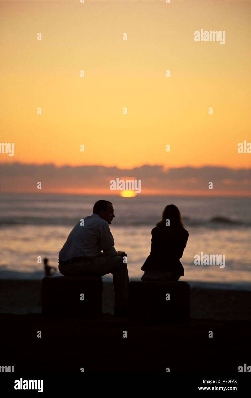 Silhouette of a couple watching the sunset Camps Bay beach Cape Town ...
