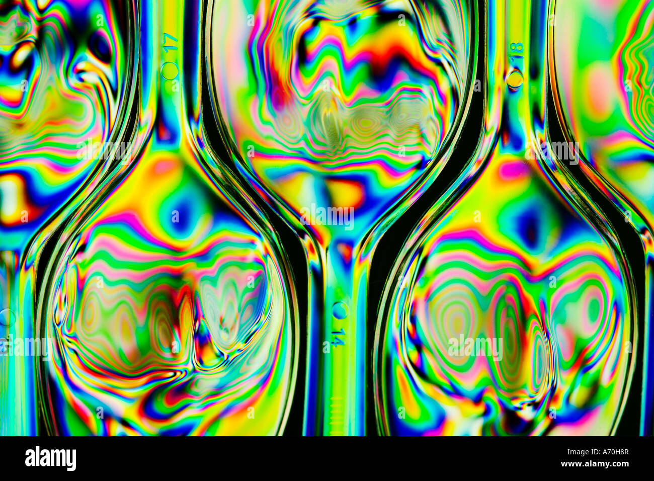 Cross Polarised abstract image of plastic spoons taken with a macro lens close-up showing stress patterns Stock Photo
