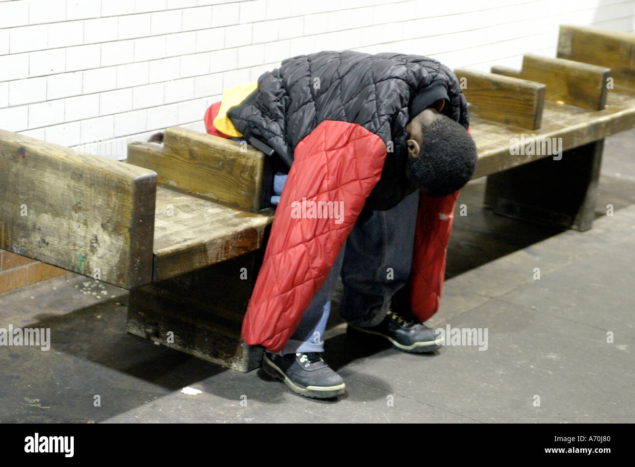 sleeping homeless man 2 New York City subway Stock Photo - Alamy
