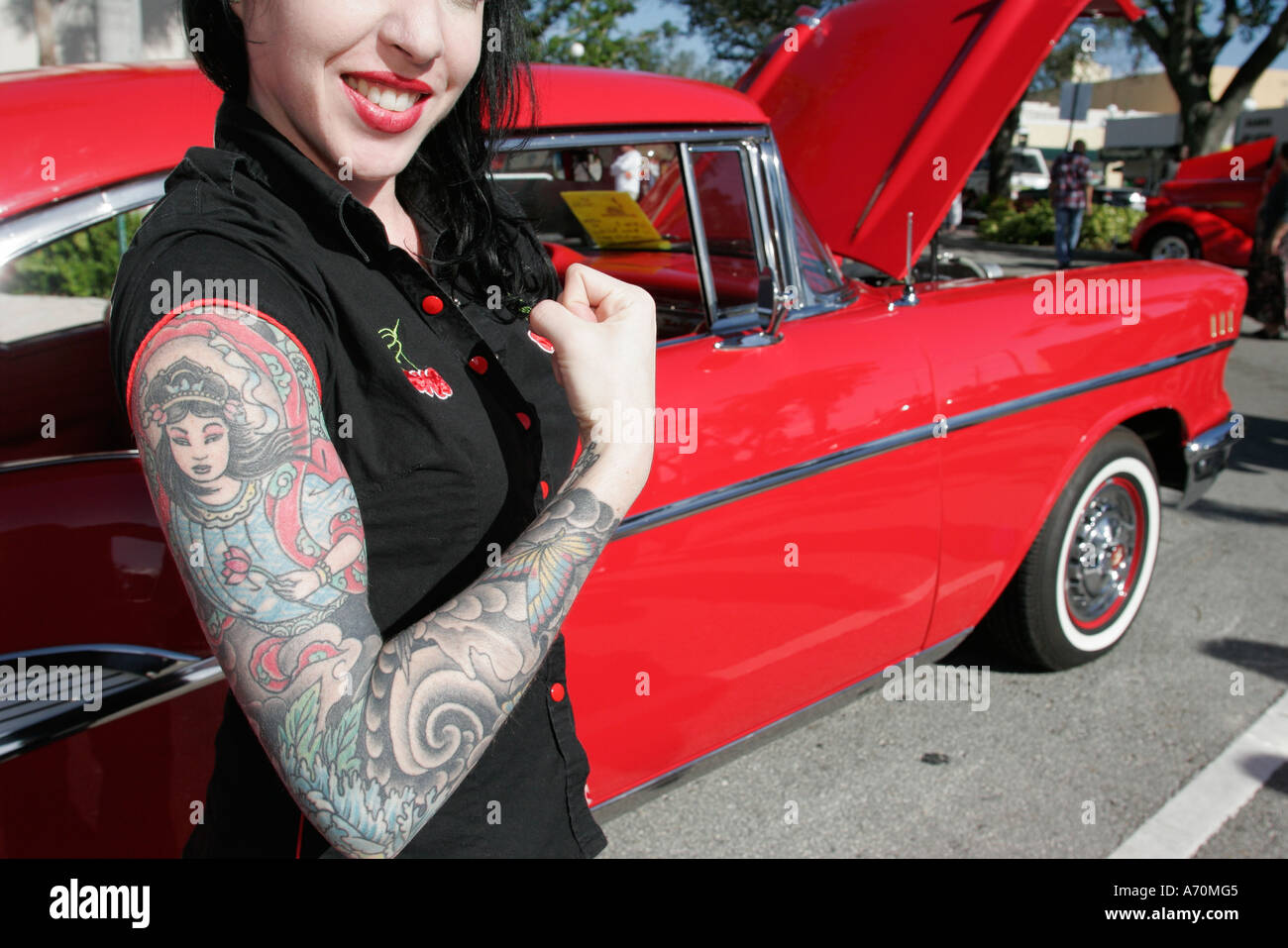 Hollywood Florida,Dream car cars Classic,antique,collector,red 1957 Chevrolet Bel Air,adult adults woman women female lady,arm,tattoo,visitors travel Stock Photo