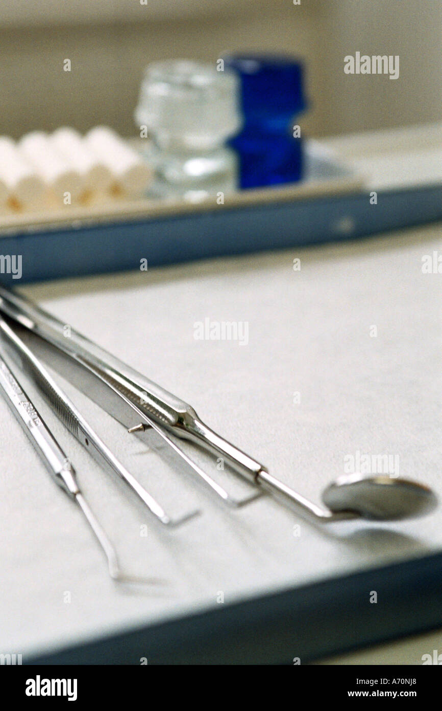 Dental practice. File at the treatment chair with mirror and hook for dental treatment Stock