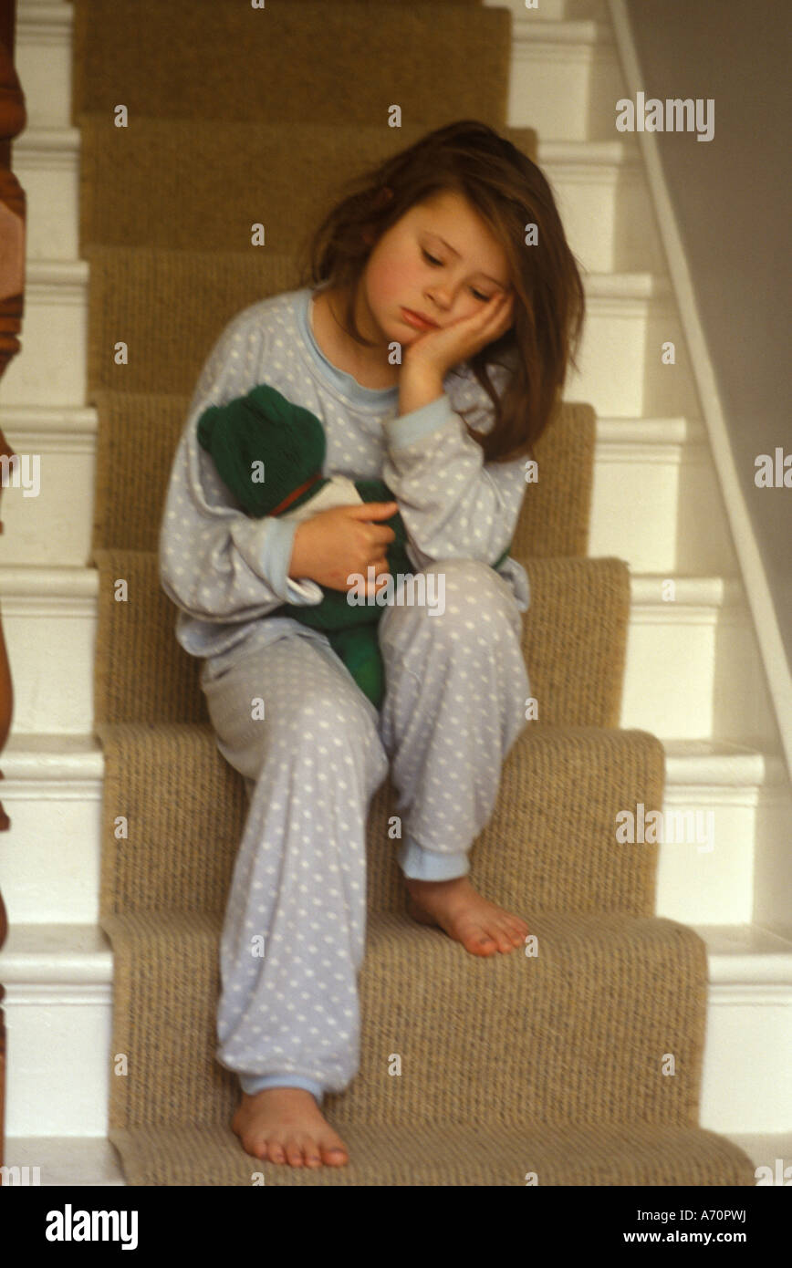 girl sitting on the stairs looking miserable Stock Photo - Alamy