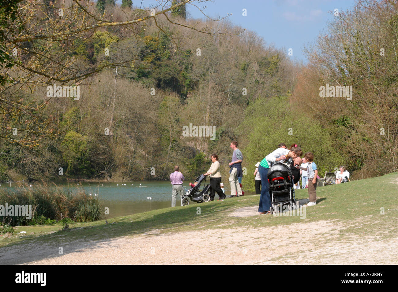 Families enjoying a sunny day in the park at Swanbourne Lake, Arundel, West Sussex, UK. Stock Photo