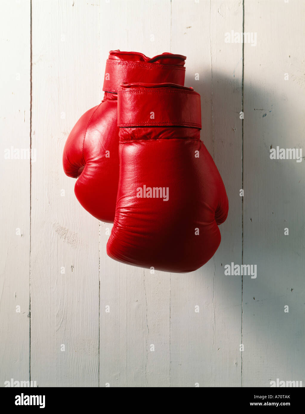 RED BOXING GLOVES HANGING ON A WOODEN WALL IN A GYM Stock Photo Alamy