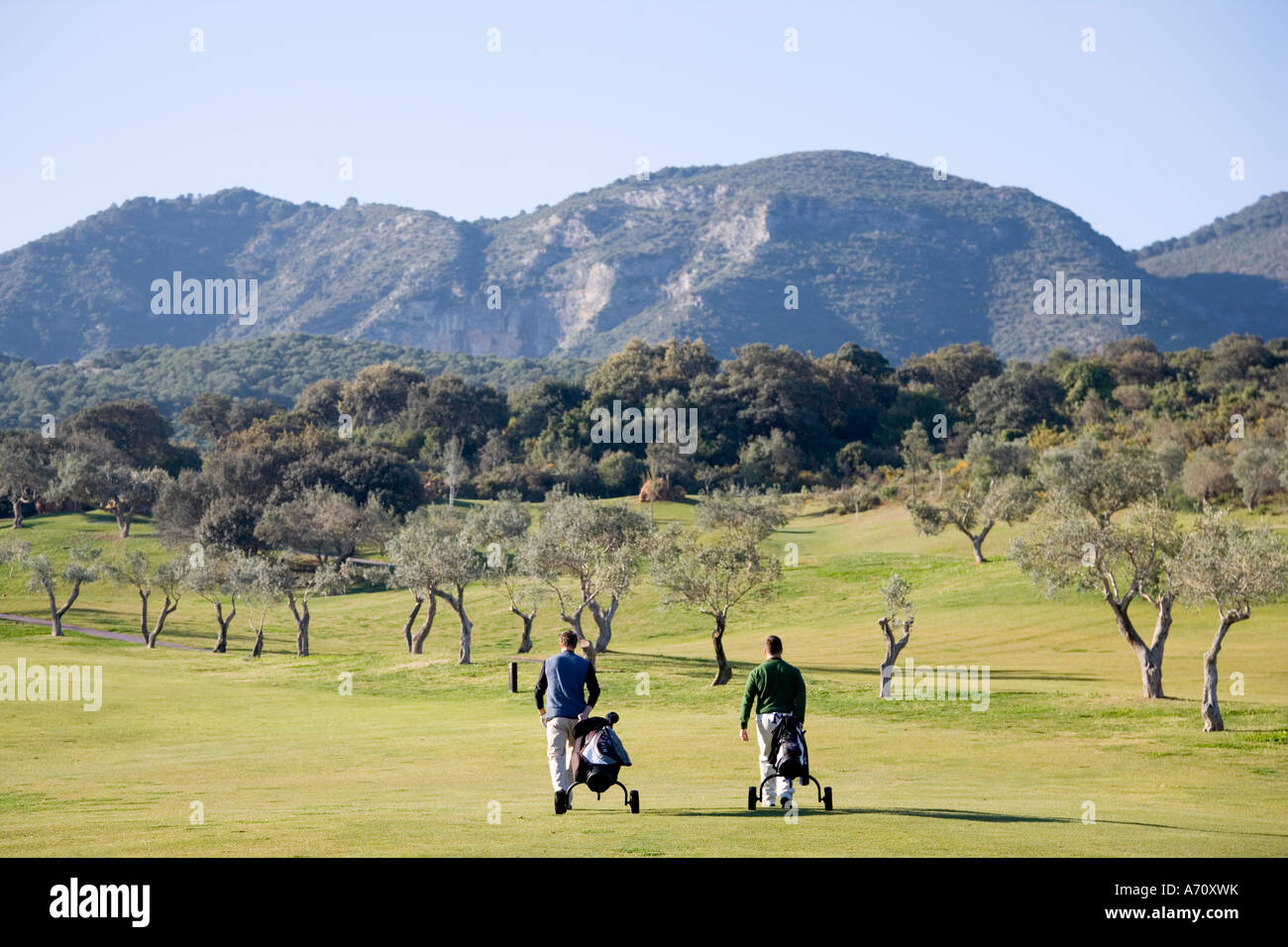 Alhaurin de la Torre,  Malaga Province,  inland Costa del Sol, southern Spain.  Lauro Golf course. Two men walking on fairway. Stock Photo