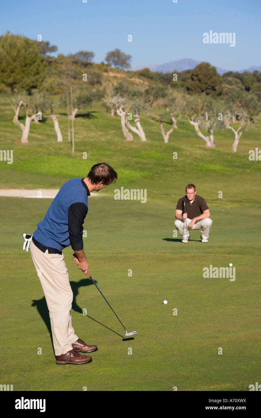 Alhaurin de la Torre,  Malaga Province,  inland Costa del Sol, southern Spain.  Lauro Golf course. Man putting on green. Stock Photo