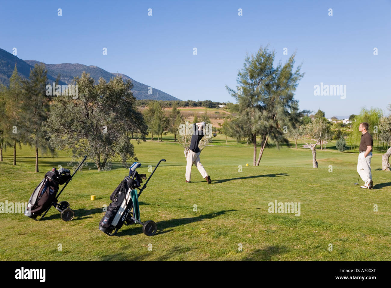 Alhaurin de la Torre,  Malaga Province,  inland Costa del Sol, southern Spain.  Lauro Golf course. Two men playing Stock Photo