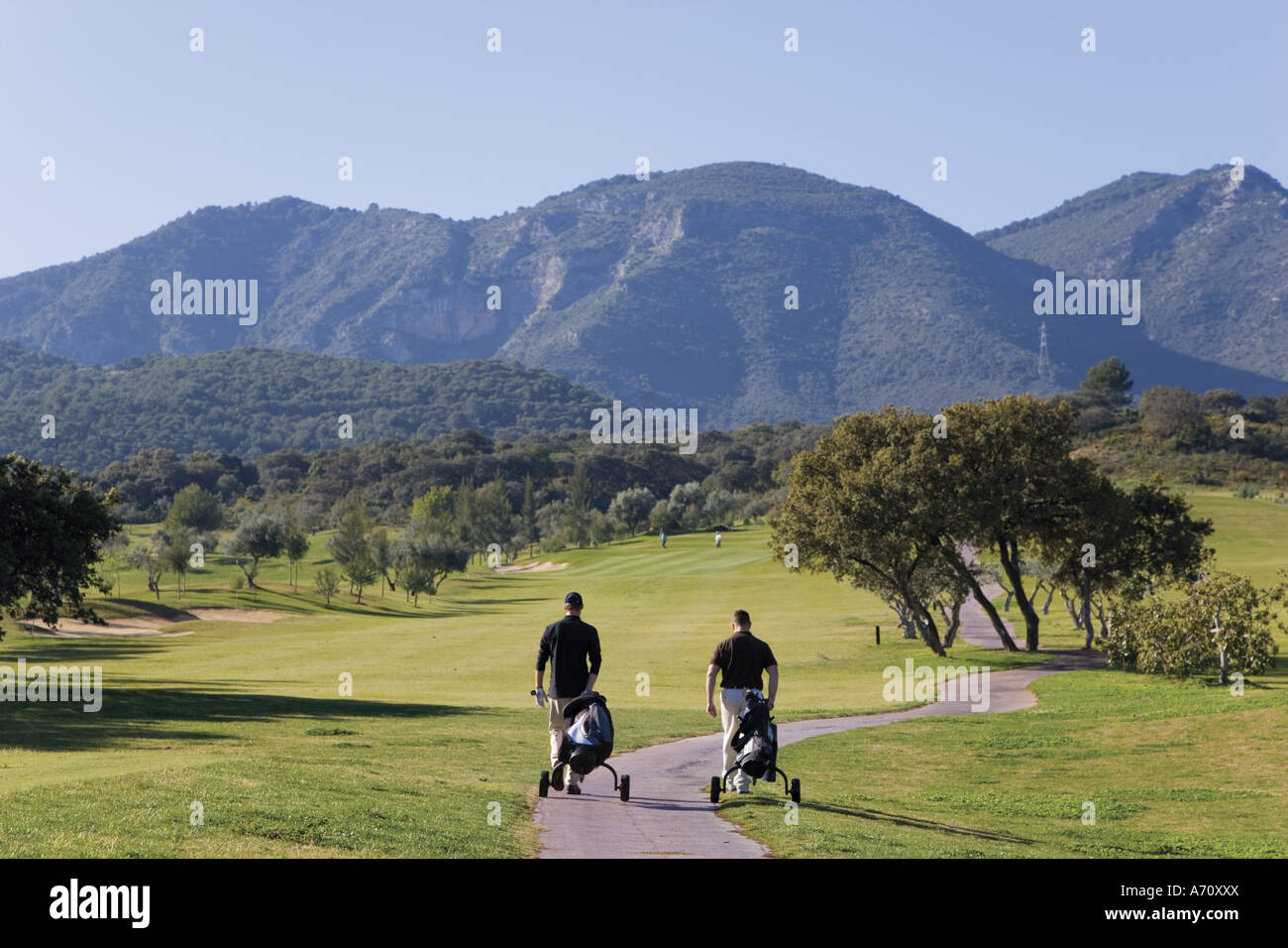 Alhaurin de la Torre,  Malaga Province,  inland Costa del Sol, southern Spain.  Lauro Golf course. Two men walking on path. Stock Photo