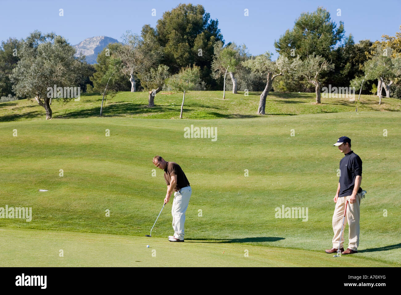 Alhaurin de la Torre,  Malaga Province,  inland Costa del Sol, southern Spain.  Lauro Golf course. Two men playing. Stock Photo