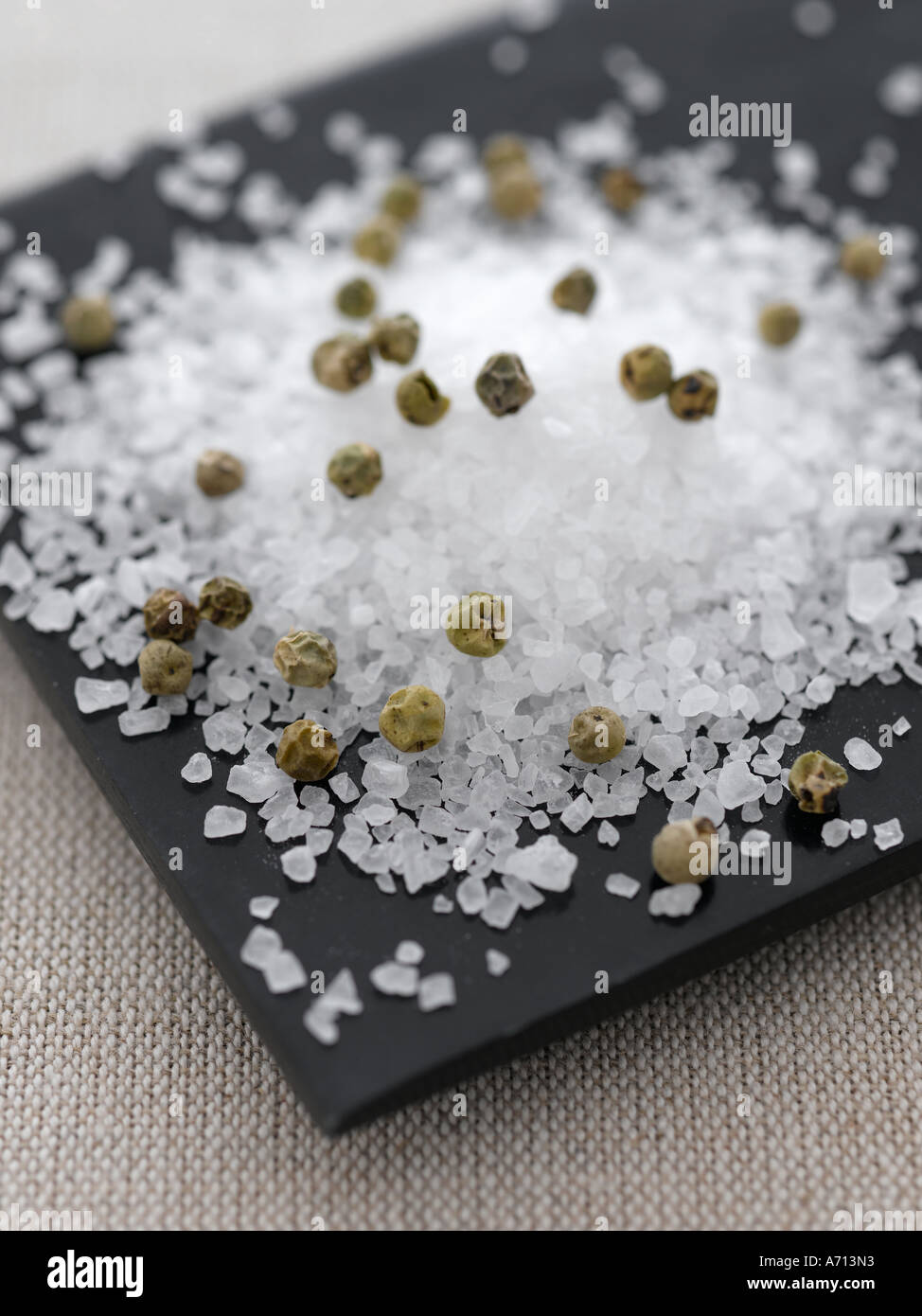 Salt and pepper on black plate and natural linen - high end Hasselblad 61mb digital image Stock Photo