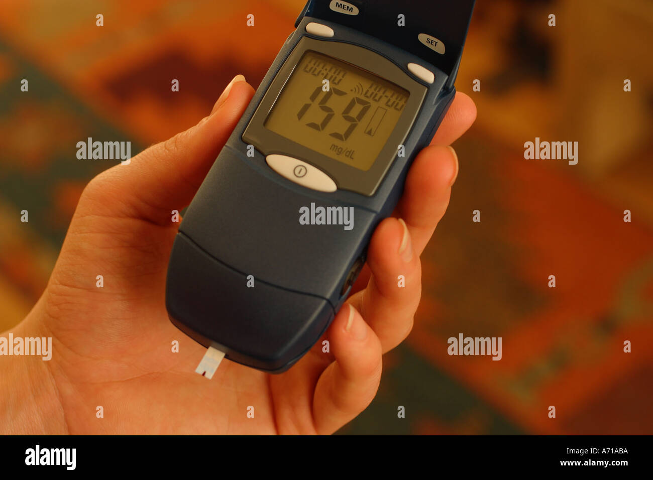 Blood glucose monitoring meter in patient s hand Stock Photo Alamy