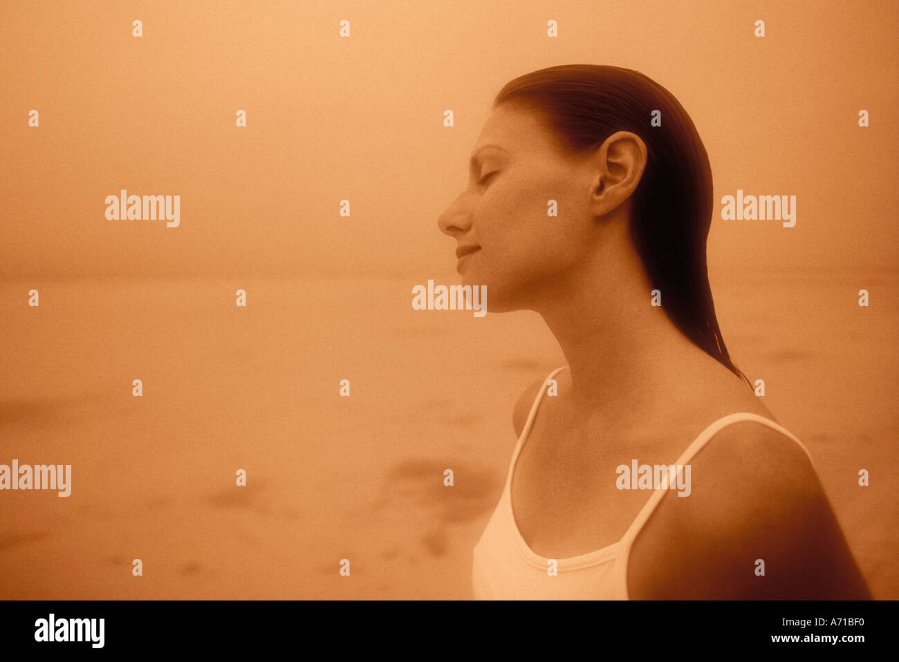 Woman with head tilted and eyes closed Aitutaki Lagoon Cook Islands South Pacific Ocean model released image Stock Photo