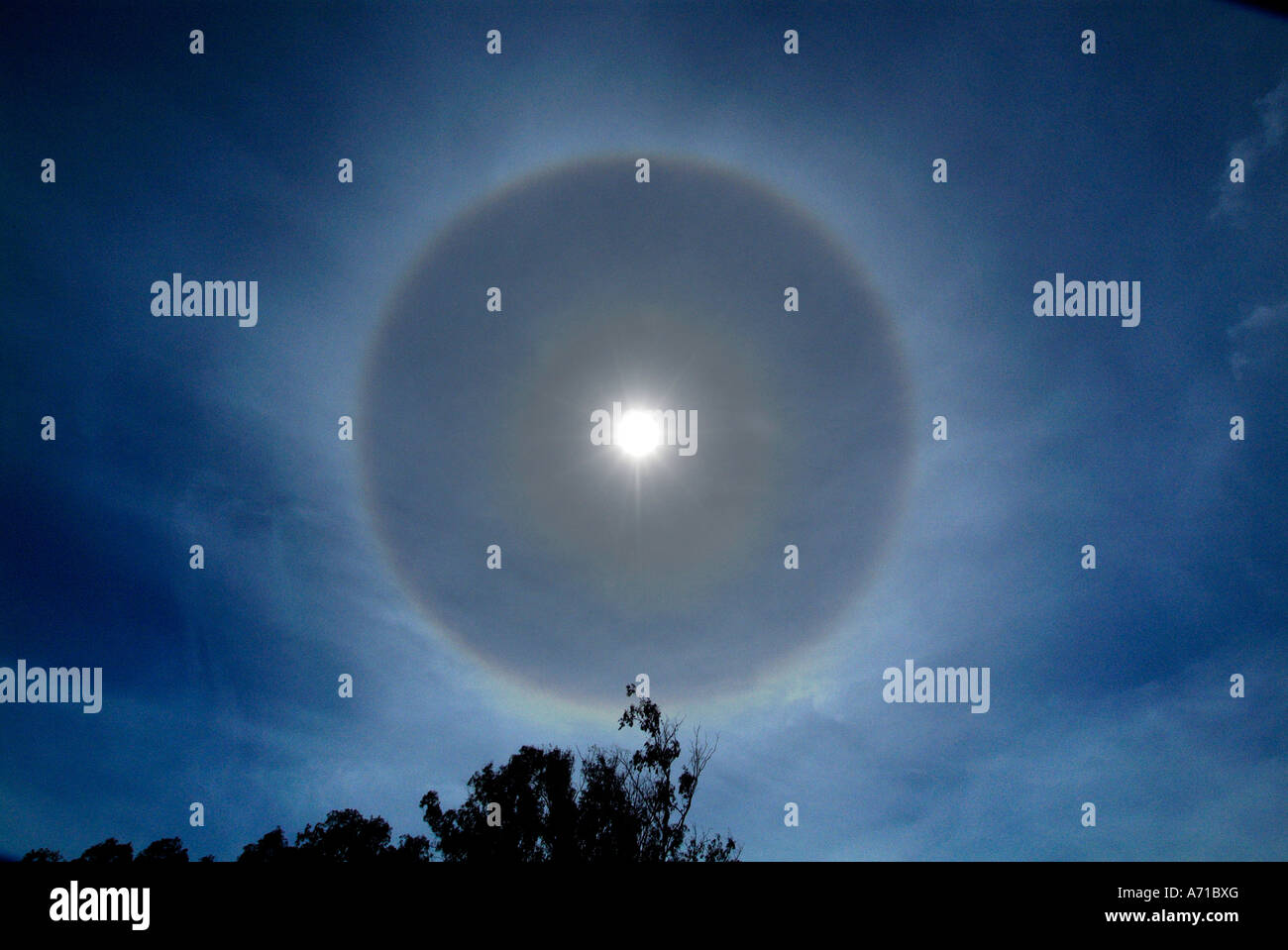 solar halo bright  luminous circle circular refraction refract refracted light lighting ice particles crystals mid day rainbow p Stock Photo