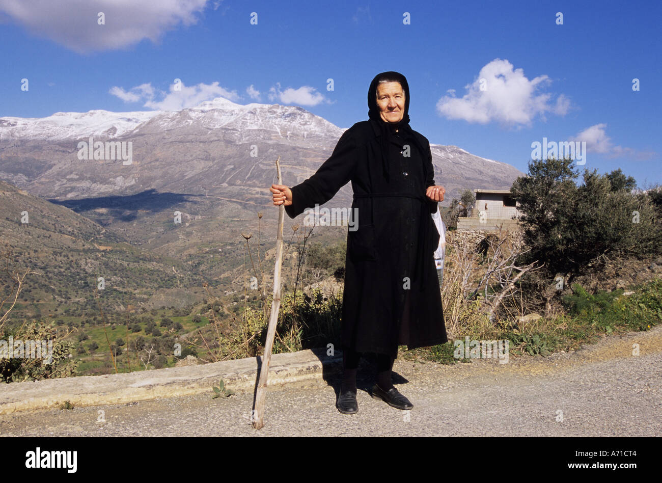 An old woman in traditional black clothes on the south side of the Island of Crete, Greece Stock Photo
