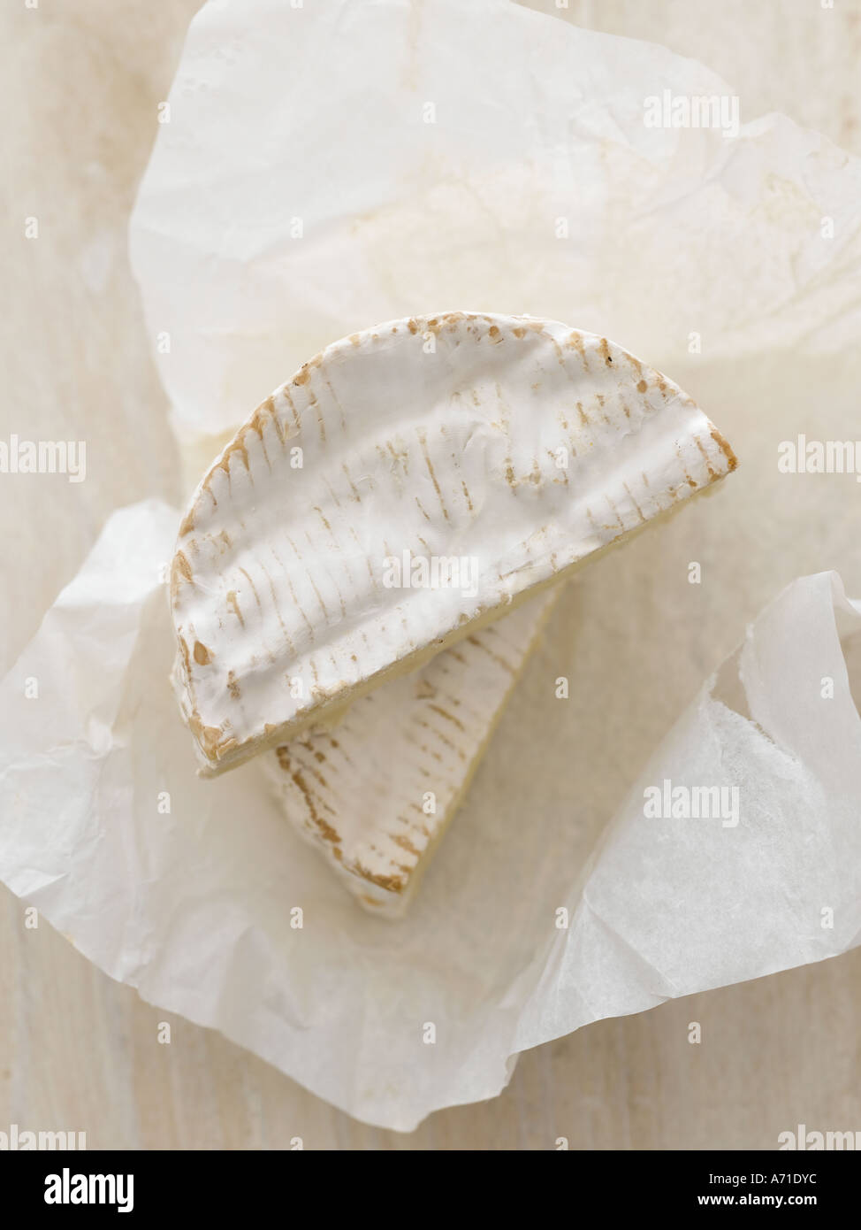 Camembert cheese on white paper and white washed wood - high end Hasselblad 61mb digital image Stock Photo