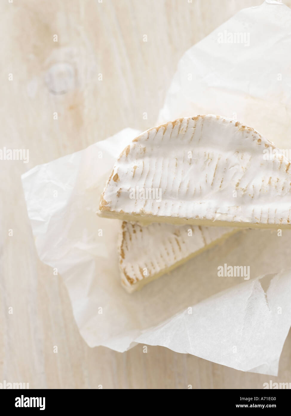 Camembert cheese on white paper and white washed wood - high end Hasselblad 61mb digital image Stock Photo