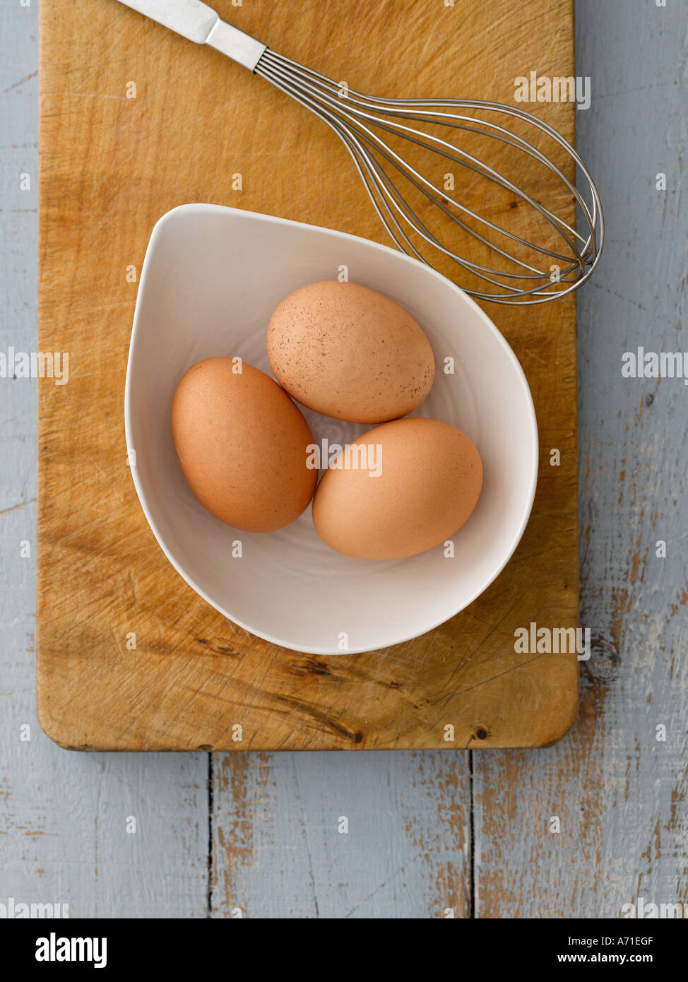 Eggs in white bowl with whisk on wooden board - high end Hasselblad 61mb digital image Stock Photo