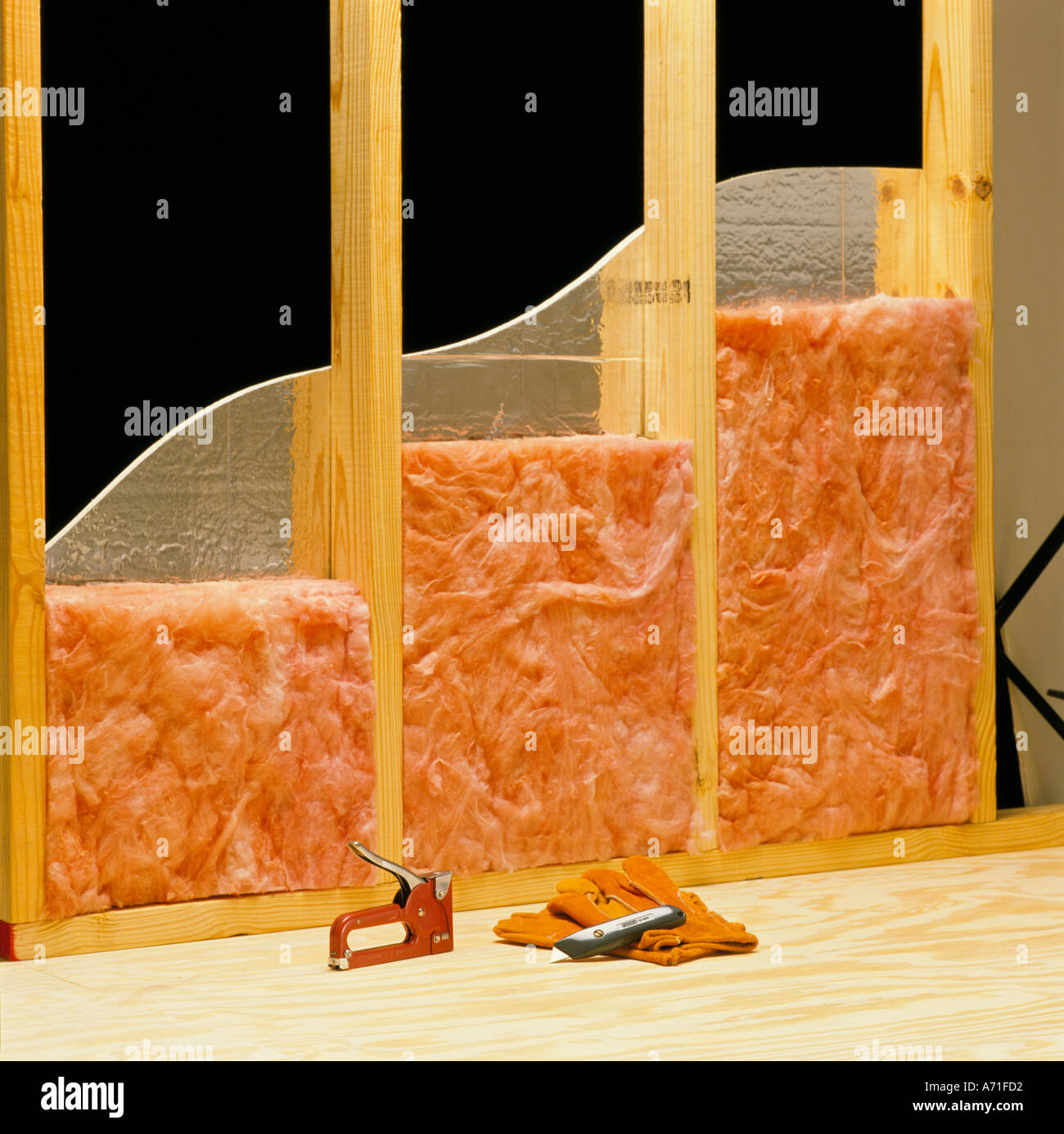 High quality wall construction with pink fiberglass insulation and a