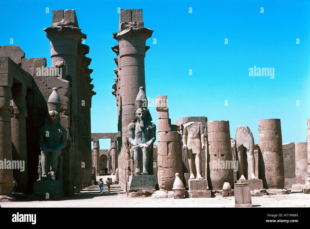 geography / travel, Egypt, Luxor, temple of Amun-Ra, court of King Ramesses, Ramses II., (reigned approx. 1290 - 1224 BC, 19th dynasty), view of colonnade of King Amenophis III. (reigned approx. 1490 - 1364 BC, 18th dynasty), seat statue of Ramesses, Ramses the great, part of complex of god Amon-Re in capital Thebes, architecture, religion, new empire, columns, column court, inner courtyard, fine arts, antiquity, historical, historic, ancient, Amun Ra, nineteenth, Amon Re, , Stock Photo