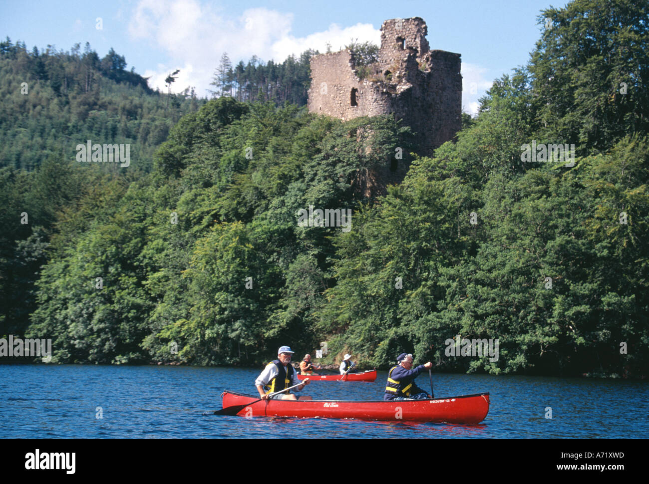 Canoeists on Loch Oich Caledonian Canal with Invergarry Castle behind Great Glen Scotland Stock Photo