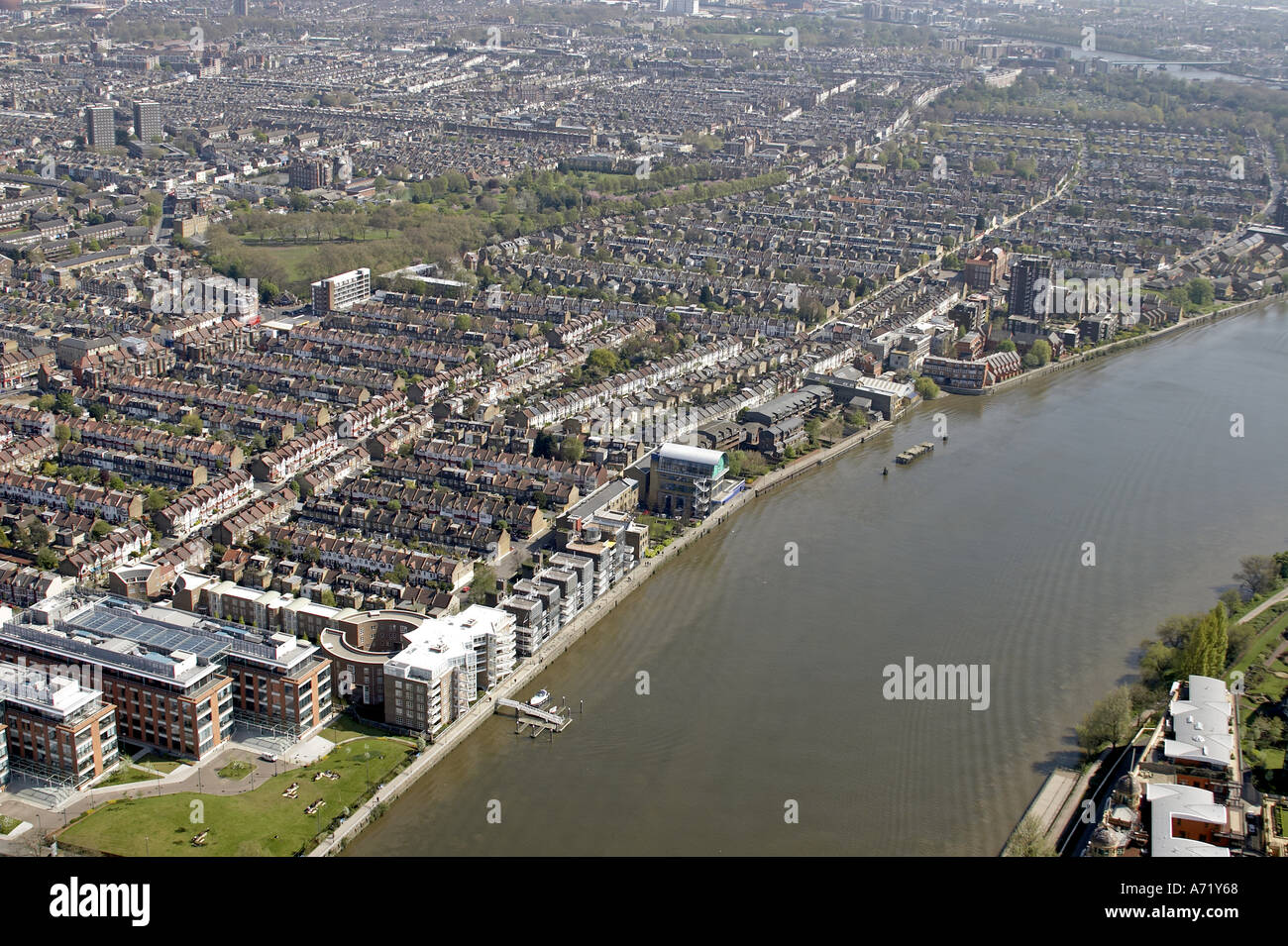 Aerial high level oblique view south east of suburbs and houses of