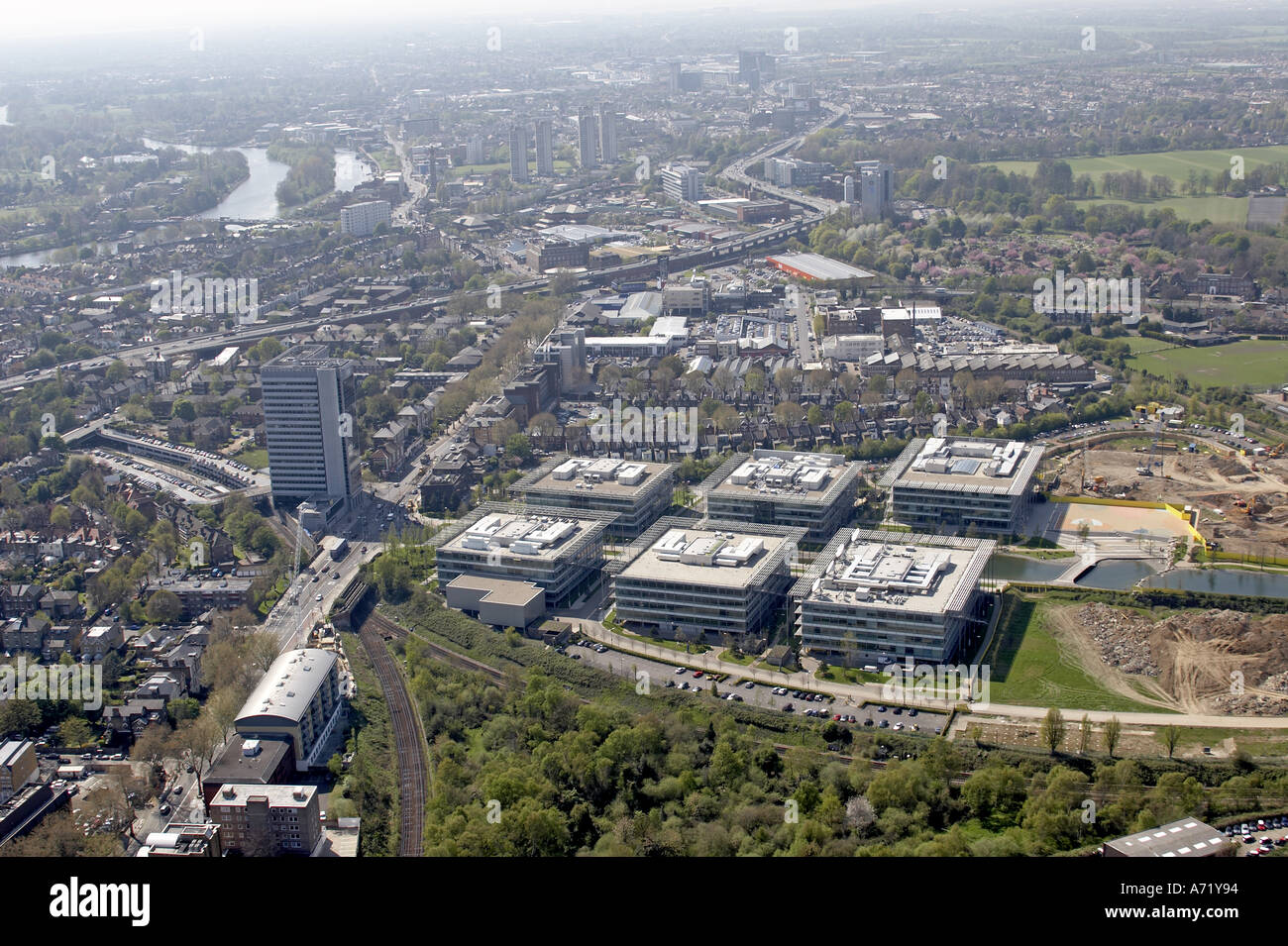 Aerial high level oblique view west of Chiswick Park with M4 Chiswick Gunnersbury Brentford and River Thames London W4 TW8 England 2005 Stock Photo