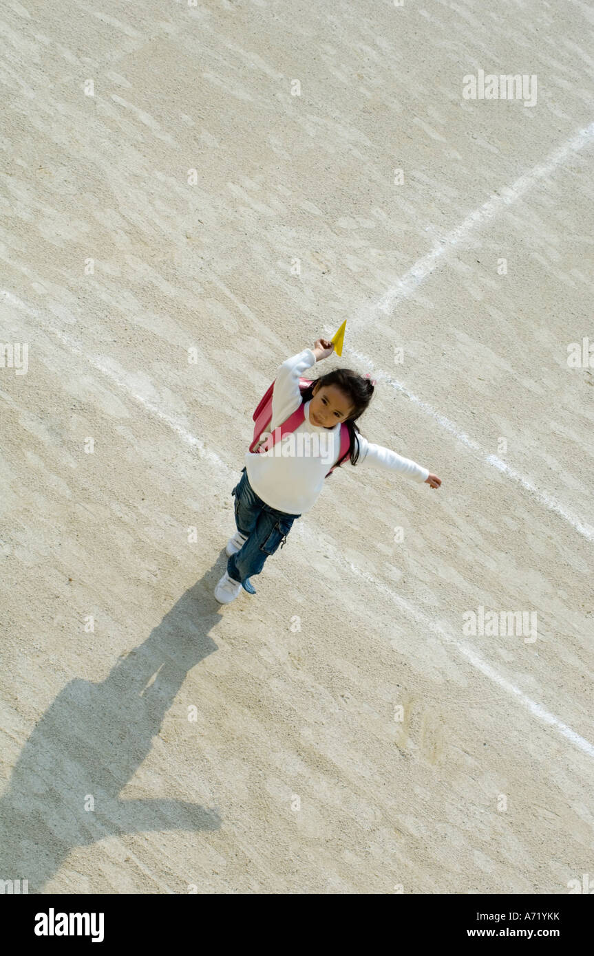Girl throwing paper airplane Stock Photo - Alamy