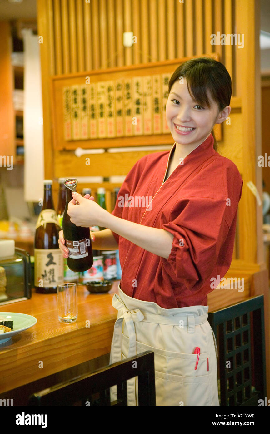Waitress opening beer bottle Stock Photo Alamy