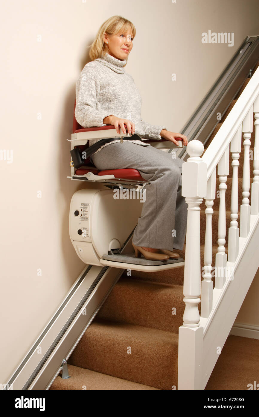 Woman using Stair lift wearing seat belt Stock Photo Alamy