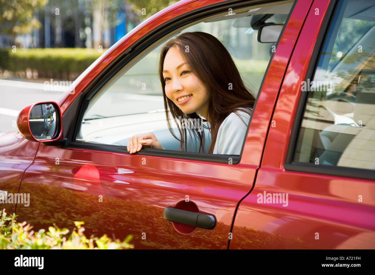 Young woman sitting in passenger seat in car Stock Photo