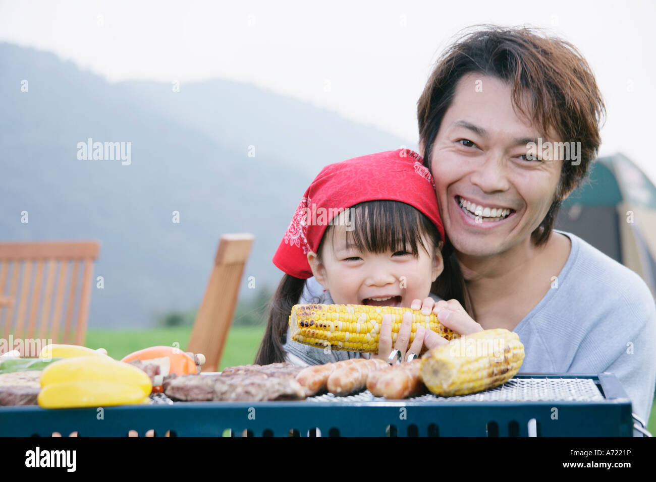 Father and daughter having barbeque Stock Photo Alamy