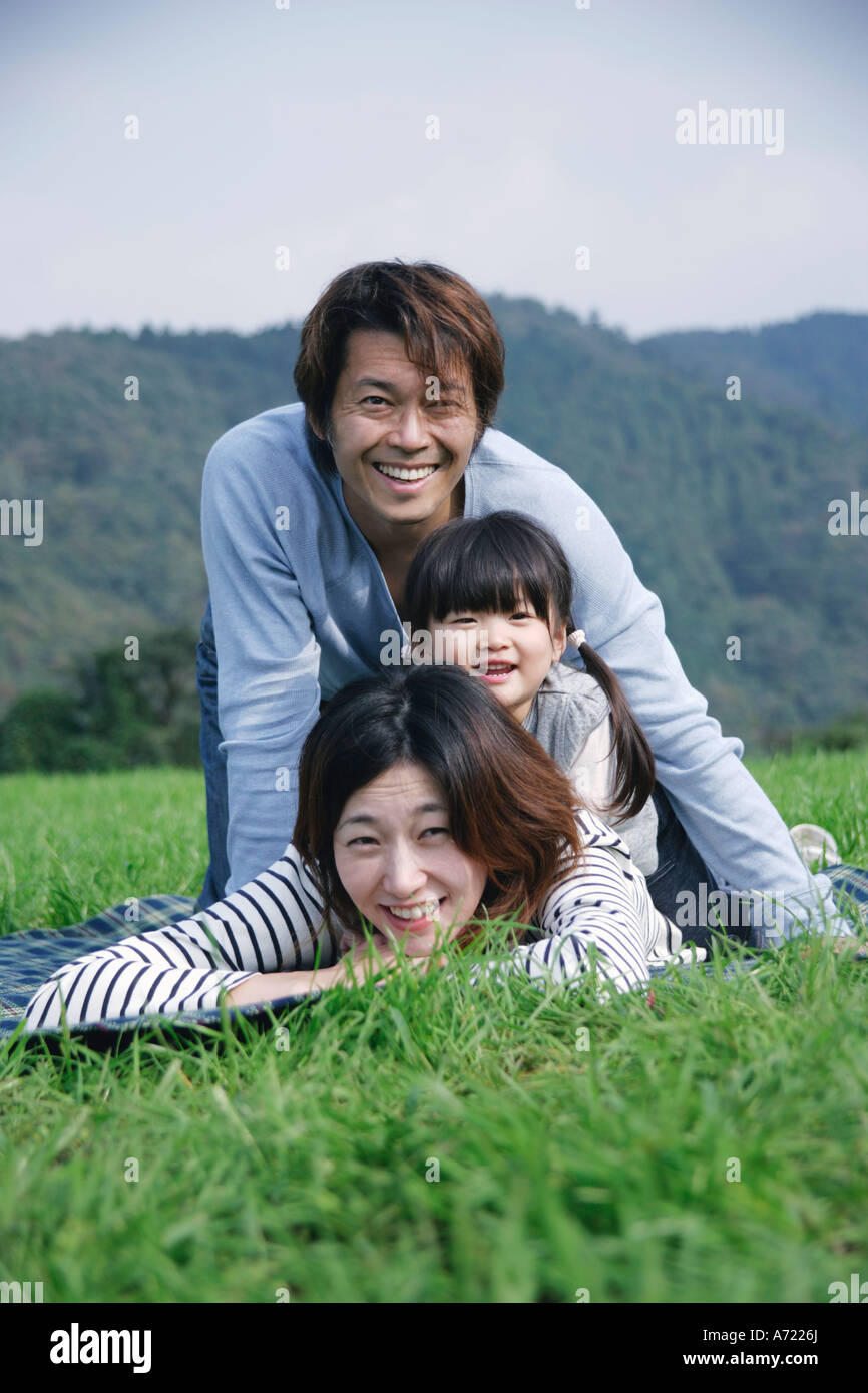 Family lying down on ground Stock Photo - Alamy